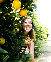 Image showing pretty woman in orange grove smiling