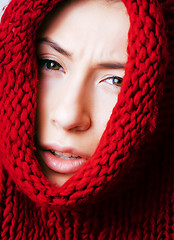 Image showing young pretty woman in sweater and scarf all over her face