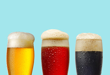 Image showing various beer glasses on blue background