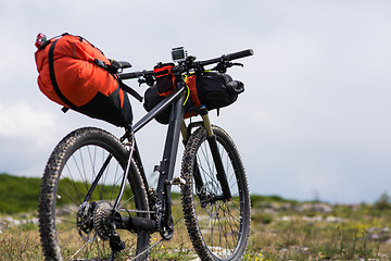 Image showing Bicycle with orange bags for travel