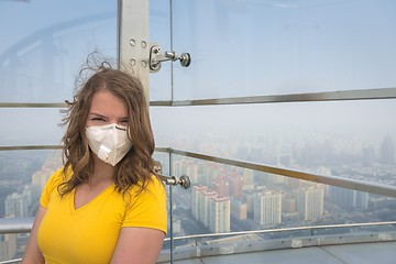 Image showing Woman in medical mask against the air pollution