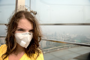 Image showing Woman in medical mask against the air pollution