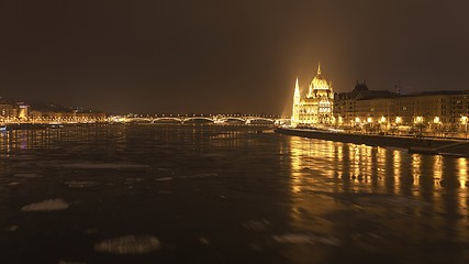 Image showing Parliament at nighttime with icy Danube