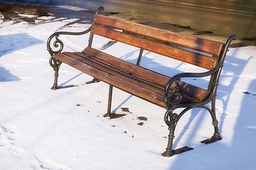 Image showing Wooden bench at winter with in the snow