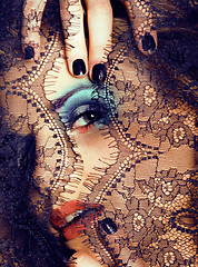 Image showing portrait of beauty young woman through lace close up mistery makeup, stylish fashion lady