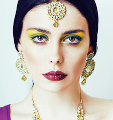 Image showing young pretty caucasian woman like indian in ethnic jewelry close up on white, bridal makeup