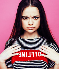 Image showing young pretty teenage woman emotional posing on pink background, fashion lifestyle people concept 