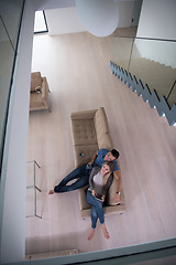 Image showing youg couple in living room with tablet top view