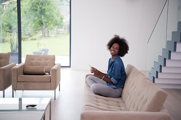 Image showing african american woman at home with digital tablet