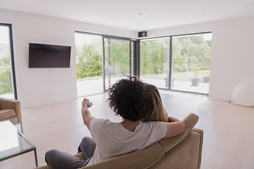 Image showing Rear view of couple watching television