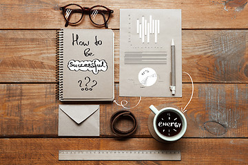 Image showing Notebook, coffee cup, glasses and pen on table. Business concept.