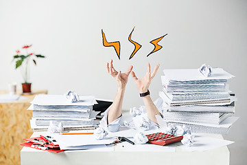 Image showing The many crumpled papers on desk of stressed male workplace