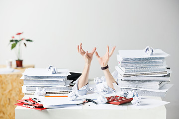 Image showing The many crumpled papers on desk of stressed male workplace