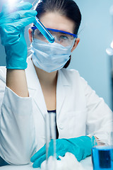 Image showing Student working with test tubes