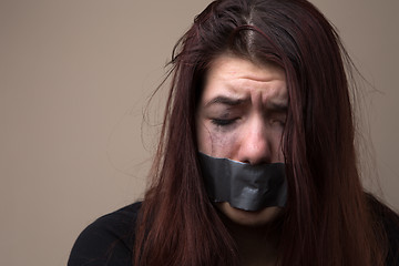 Image showing Crying girl with gray tape