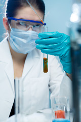 Image showing Young researcher handling chemical agents