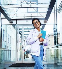 Image showing young cute modern indian girl at university building sitting on 