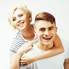 Image showing young pretty teenage couple, hipster guy with his girlfriend happy smiling and hugging isolated on white background, lifestyle people concept 