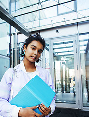 Image showing young cute modern indian girl at university building sitting on 