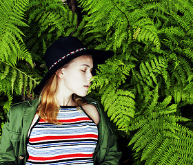 Image showing Pretty young blond girl hipster in hat among fern, vacation in g