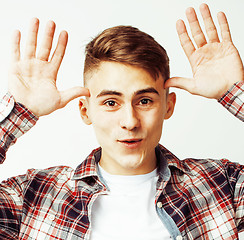 Image showing young handsome teenage hipster guy posing emotional, happy smiling against white background isolated, lifestyle people concept 