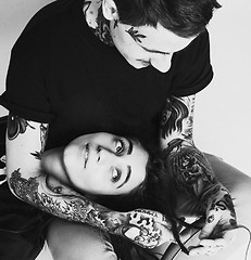 Image showing Young couple together making love, hugging. guy with tattoo, gir