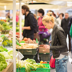Image showing Woman buying vegetable at local food market. 
