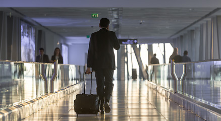 Image showing Businessman at airport corridor walking to departure gates.