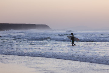 Image showing Surfers on beach with surfboard.