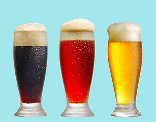 Image showing various beer glasses on blue background