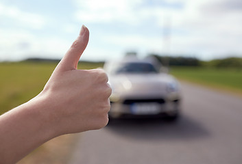 Image showing hitchhiker stopping car with thumbs up hand sign