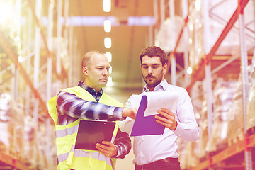 Image showing worker and businessmen with clipboard at warehouse