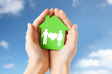 Image showing hands holding green house with family pictogram