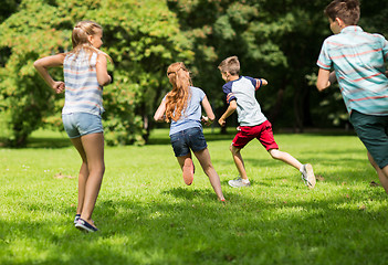 Image showing group of happy kids or friends playing outdoors