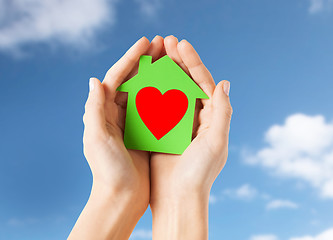 Image showing hands holding green paper house with heart shape