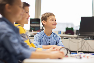 Image showing happy children building robots at robotics school