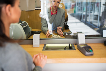 Image showing clerk with cash money and customer at bank office