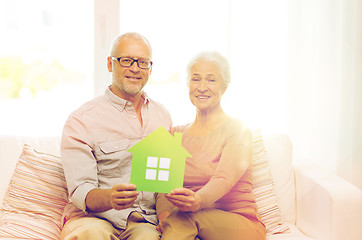 Image showing happy senior couple hugging on sofa at home