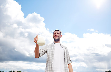 Image showing man or farmer with jug of milk at countryside