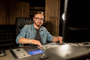 Image showing man at mixing console in music recording studio