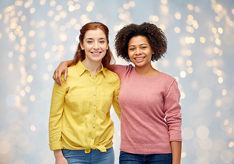 Image showing happy smiling women hugging over holidays lights