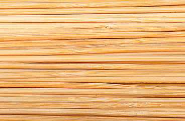 Image showing Bamboo sticks stacked next to each other