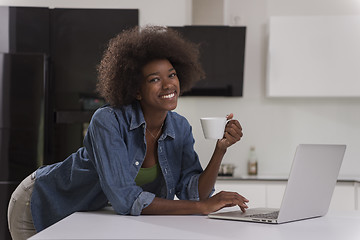 Image showing smiling black woman in modern kitchen