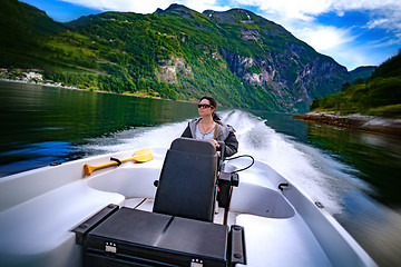 Image showing Woman driving a motor boat