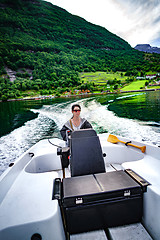 Image showing Woman driving a motor boat