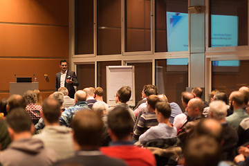 Image showing Business speaker giving a talk in conference hall.