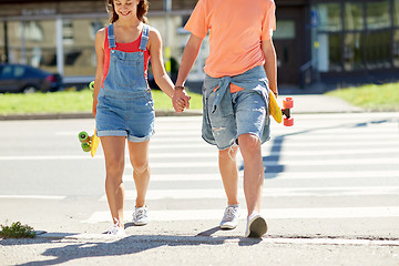 Image showing teenage couple with skateboards at city crosswalk