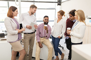 Image showing happy business team drinking coffee at office