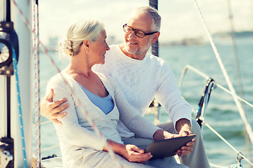 Image showing senior couple with tablet pc on sail boat or yacht