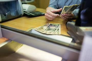Image showing clerk counting cash money at bank office